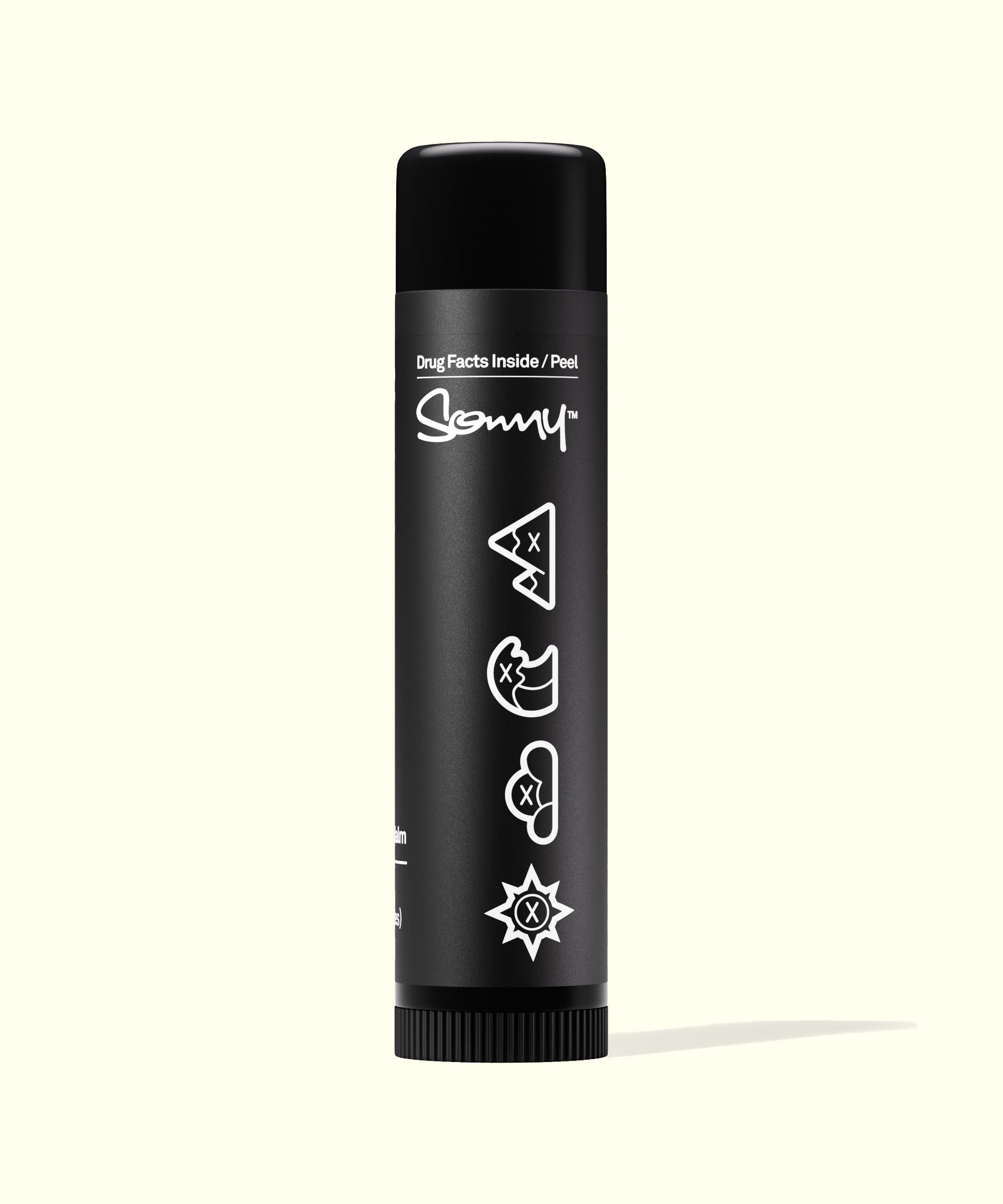 Back view of Sun Bum Signature SPF 30 Mineral Lip Balm black tube with playful icons on label