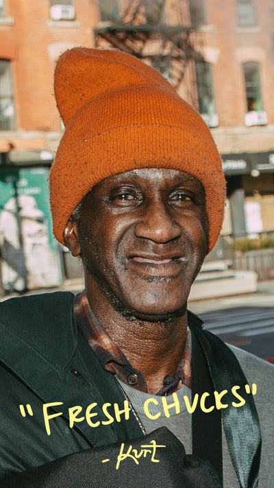 Man wearing an orange beanie with 'Fresh Chucks' text overlay