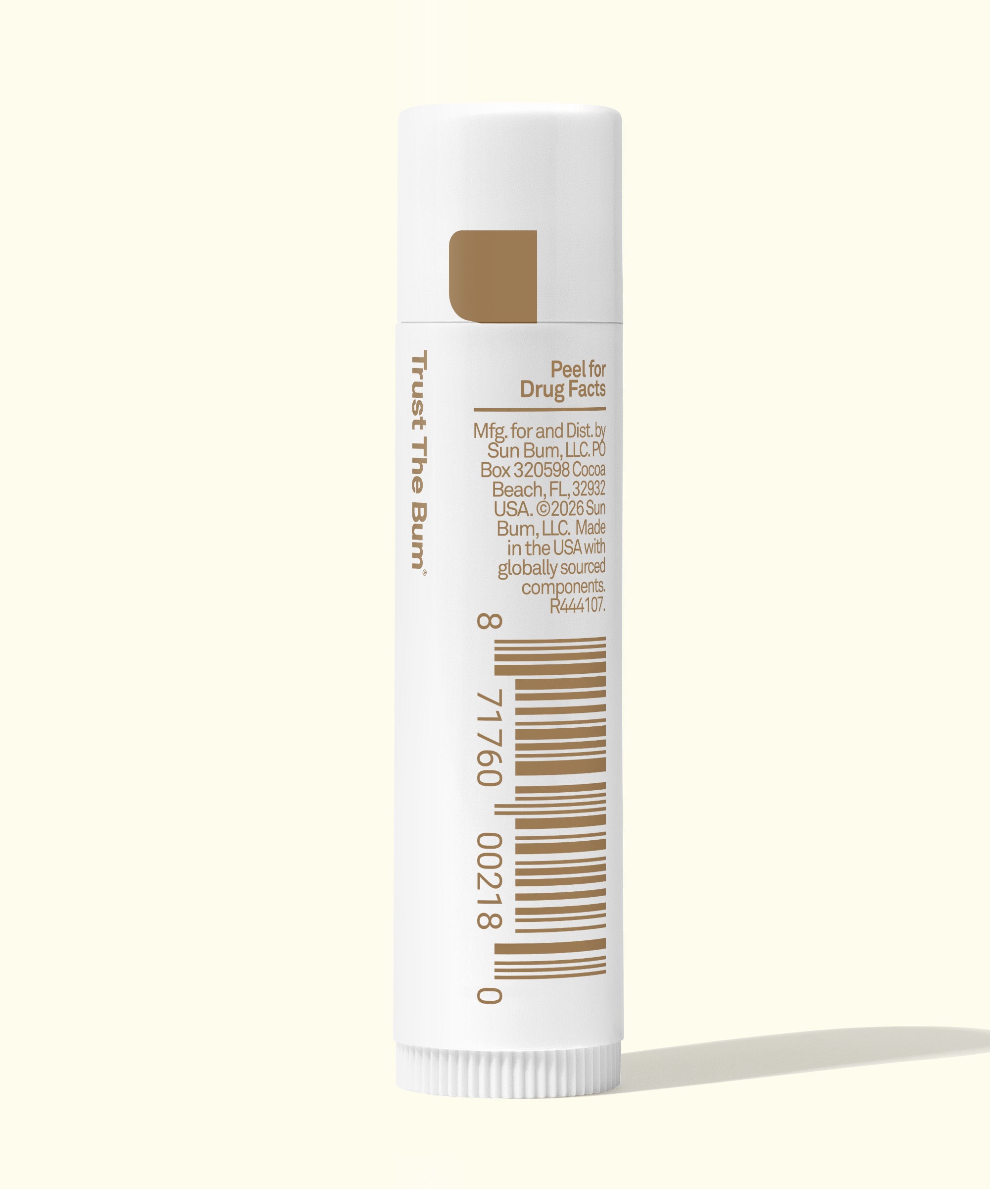 Sunscreen stick with white packaging and brown text on a white background