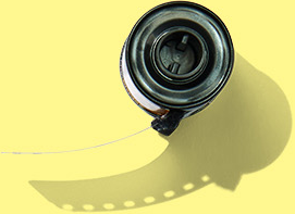 Close-up of a roll of film with a camera lens on a yellow background